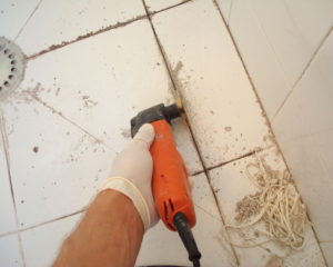 Tile grout removing and regrouting