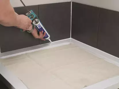 Resealing shower base tiles